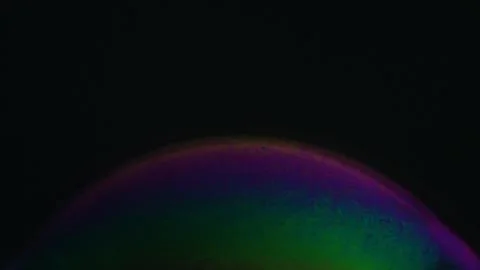 Rainbow soap bubble on a dark background. Close-up of colorful surface Stock Illustration
