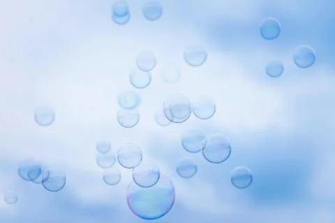 Rainbow Soap Bubbles on Blue Sky Background Stock Photos