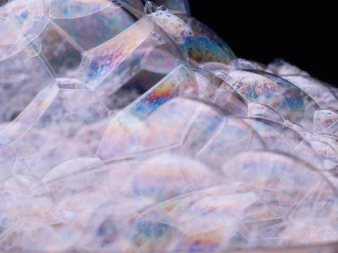 Rainbow soap bubbles close-up. Abstract pattern. Macro shot of soap foam on Stock Photos