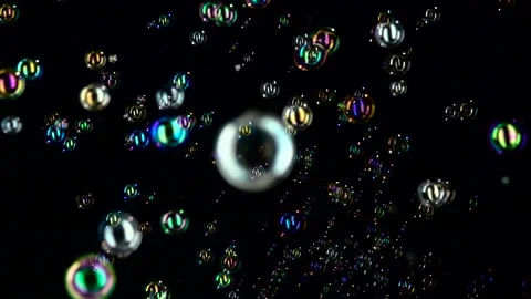 Rainbow soap bubbles fly. Slow motion. Black background Stock Footage 98006387