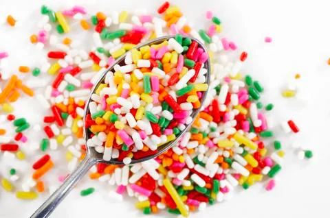 Rainbow sprinkles in spoon Stock Photos