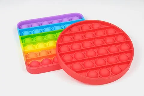 Rainbow Square and Red round Fidget Toys Pop-it on the white background Stock Photos