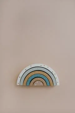 Rainbow stacking toy on neutral soft pastel beige colour background. Flat lay Stock Photos