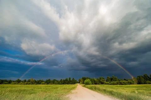 Rainbow in storm clouds, road to the rainbow Stock Photos