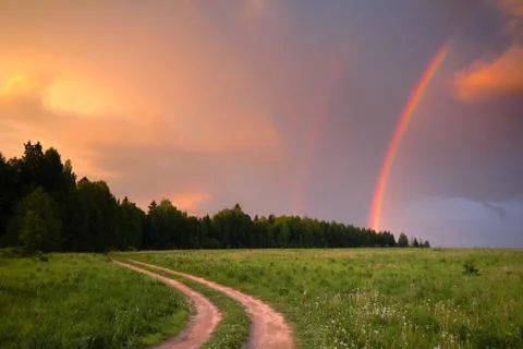Rainbow in summer in the field Stock Photos