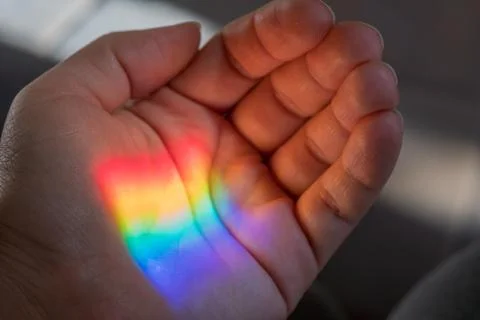 Rainbow sun light on a hand Stock Photos