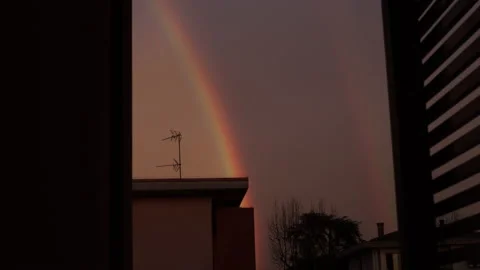 Rainbow at sunset time. Urban cityscape. House and pink sky Stock Footage 152184053