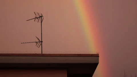 Rainbow at sunset time. Urban cityscape. Pink sky Stock Footage 152185022