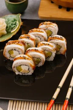 Rainbow Sushi Roll with salmon, eel, tuna, avocado, royal prawn, cream cheese Stock Photos