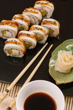 Rainbow Sushi Roll with salmon, eel, tuna, avocado, royal prawn, cream cheese Foto stock