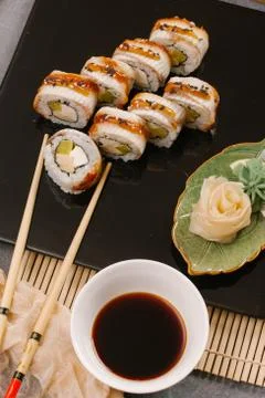 Rainbow Sushi Roll with salmon, eel, tuna, avocado, royal prawn, cream cheese Stock Photos