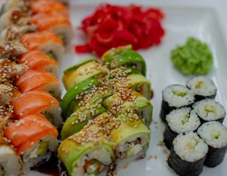Rainbow Sushi Roll with salmon, eel, tuna, avocado, royal prawn, cream cheese Stock Photos