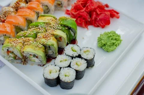 Rainbow Sushi Roll with salmon, eel, tuna, avocado, royal prawn, cream cheese Stock Photos