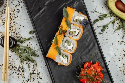 Rainbow Sushi Roll with salmon, eel, tuna, avocado, royal prawn, cream cheese Stock Photos
