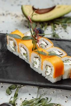 Rainbow Sushi Roll with salmon, eel, tuna, avocado, royal prawn, cream cheese Stock Photos