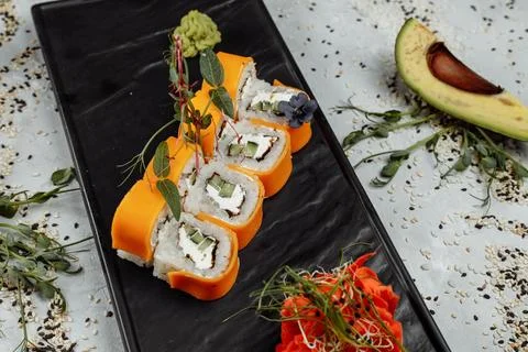 Rainbow Sushi Roll with salmon, eel, tuna, avocado, royal prawn, cream cheese Stock Photos