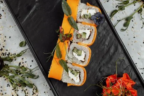 Rainbow Sushi Roll with salmon, eel, tuna, avocado, royal prawn, cream cheese Stock Photos