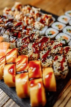 Rainbow Sushi set with salmon, eel, tuna, avocado, royal prawn, cream cheese Foto stock