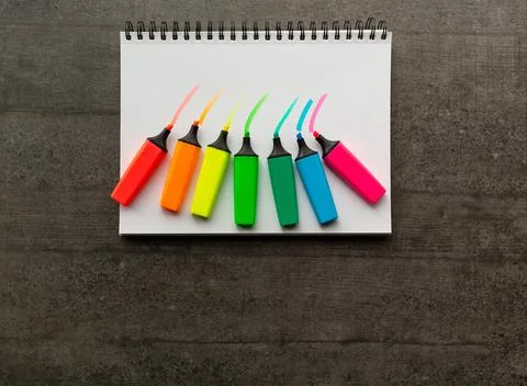 Rainbow text markers on a sheet of white sketching paper. Stock Photos