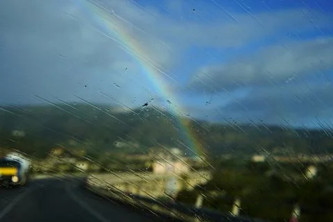 A rainbow through a wet car windshield. Stock-Fotos
