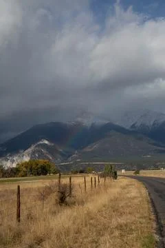 Rainbow touching mountain Stock Photos