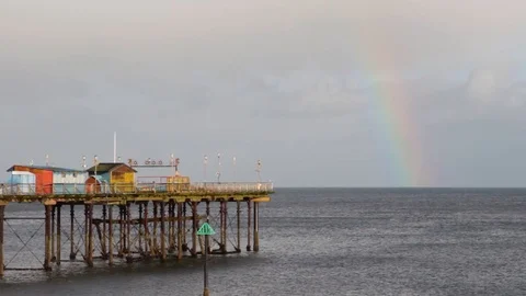 Rainbow towers majestically over a Cornish Pier Stock-Footage 85739306