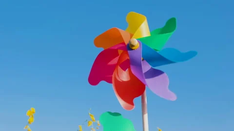 Rainbow turbines in wind on blue sky Video stock 166129740