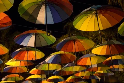 Rainbow umbrellas in a dark Stock Photos