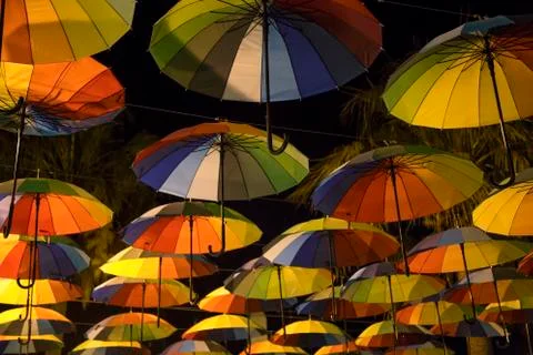 Rainbow umbrellas in a dark Stock Photos