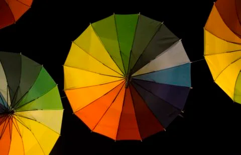 Rainbow umbrellas in a dark Stock Photos