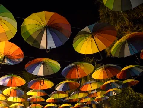 Rainbow umbrellas in a dark Stock Photos
