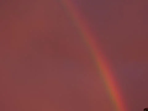 Rainbow under a red sunset sky Stockfoto's