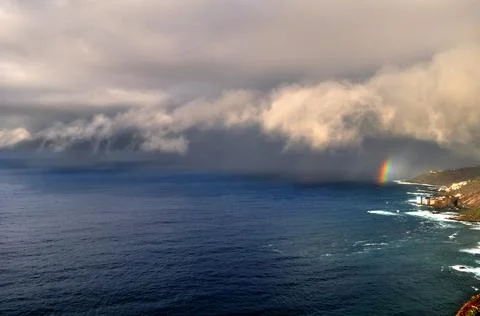 The rainbow warns of the arrival of the rain Stock Photos