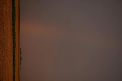 Rainbow on wheat field during a summer storm at sunset Foto stock