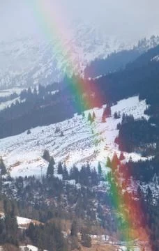 Rainbow in winter mountains Stock Photos