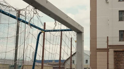 Raindrenched goal with rusted net in abandoned cityscape scene, Wet football Stock Footage 337656488
