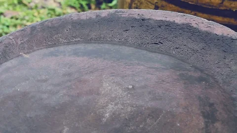 Raindrop falling to bottom of big earthen jar Stock Footage 80640377