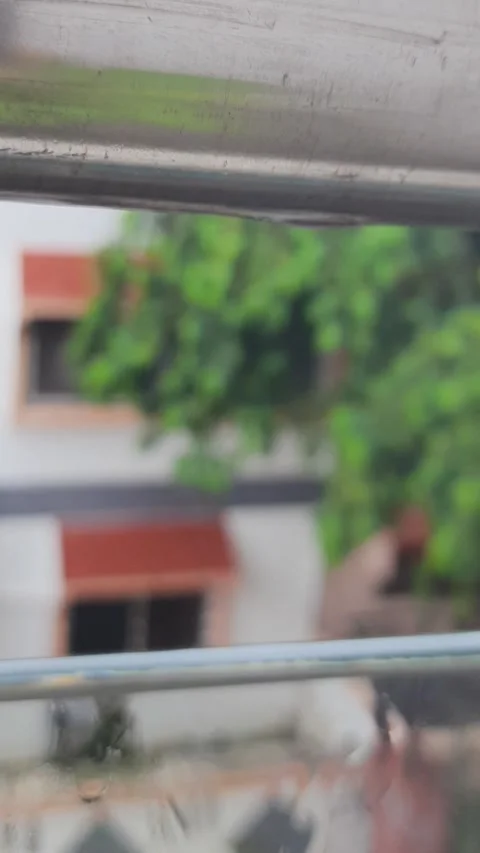 Raindrop Falling from Metal Railing onto Glass Window Close Up 動画素材 339193848