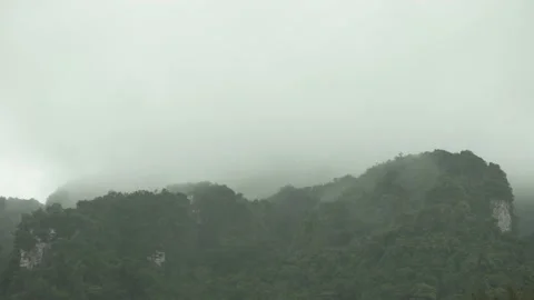 Raindrop in foreground Cloudy and mist on sky over  island mountain Stock Footage 153506184