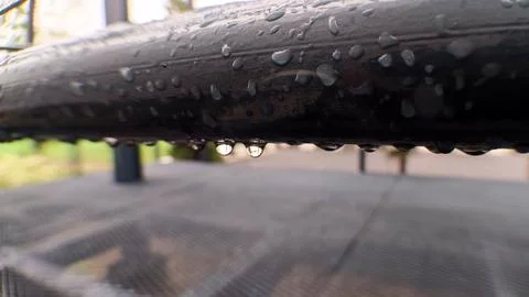 Raindrop on a metal railing Stock Photos