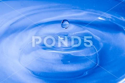 Raindrop photographed as it falls. Stock Photos