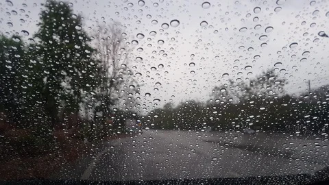 Raindrop on the side mirror of car and traffic movement on highway road Stock Footage 129352209