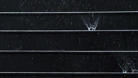 Raindrop splash on black stair step Stock Footage 233362037