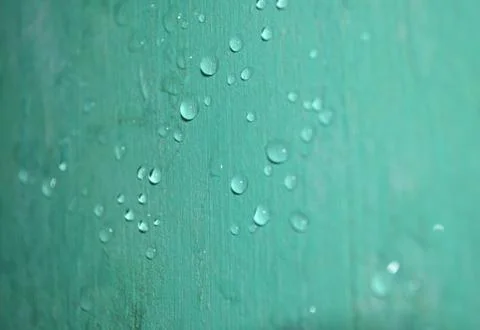 Raindrop on the wall are shiny green due to the reflection Stock Photos