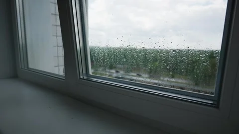 Raindrops Accumulating on Modern Window Frame in Gloomy Day Close-Up 스톡 동영상 345426090