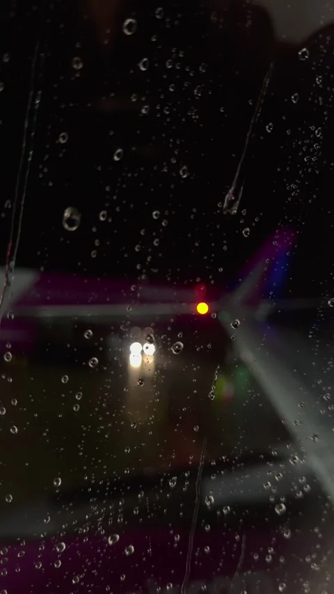 Raindrops on airplane window Stock Footage 332684135