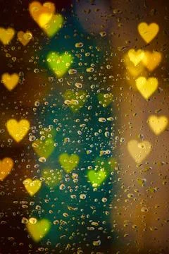 Raindrops and bokeh lights on the window Stock Photos