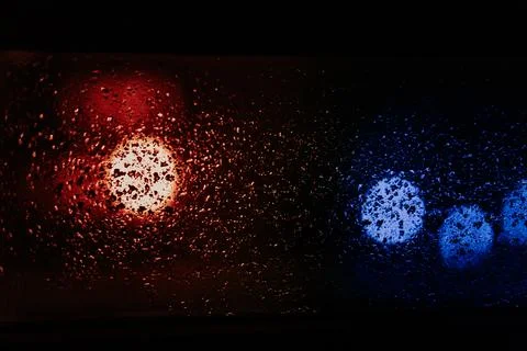 Raindrops and condensation on window at night with street lights Stock Photos