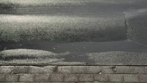 Raindrops and Puddle Ripples on Wet Asphalt by Curb Stock Footage 340512550