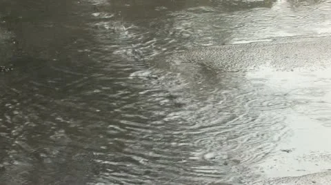 Raindrops and the puddle of water Stock Footage 11689131